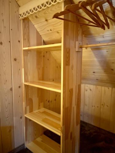 a wooden cabinet with wooden shelves in a room at Willa Pod Orłem Jacuzzi Sauna in Kościelisko