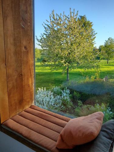 a window seat with a view of a tree at côté verger B&B in Battice