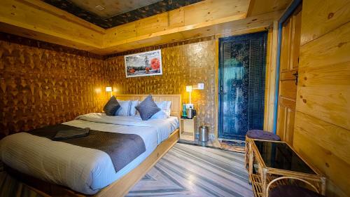 a bedroom with a bed in a wooden room at Neelkanth Cozy Stays Mukteshwar in Mukteswar