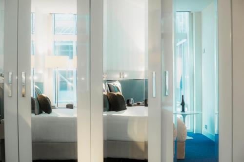 a bedroom with a bed and a window at Novotel Melbourne On Collins in Melbourne