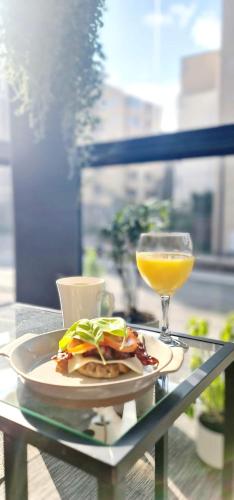 a plate of food and a drink on a table at The Pearl of Pasila in Helsinki