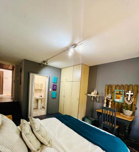 a bedroom with a large bed and a desk at Follyfoot Manor in Midrand