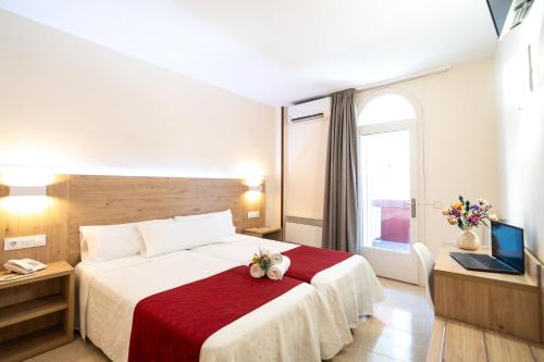 a hotel room with a bed and a television at Hotel Europa in Figueres