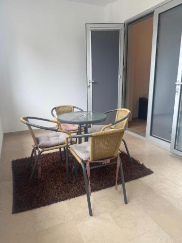 a table and two chairs and a glass table and chairs at Apartman Kovač in Posušje