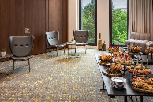 a waiting room with a buffet of food on a table at Melia Luxembourg in Luxembourg