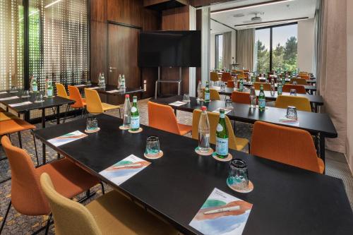 a conference room with tables and chairs with bottles on them at Melia Luxembourg in Luxembourg