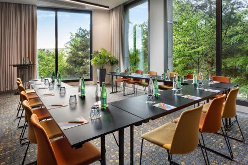 a conference room with tables and chairs and large windows at Melia Luxembourg in Luxembourg