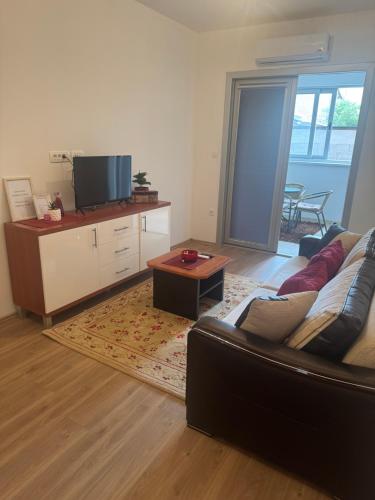 a living room with a couch and a table at Apartman Kovač in Posušje