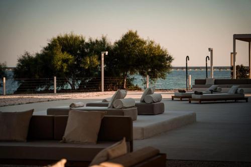 a group of couches sitting on a patio near the water at Villa Julia in Manfredonia
