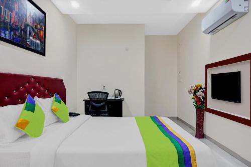 a bedroom with a bed and a tv on the wall at Hotel Chhaava Executive in Jāmb