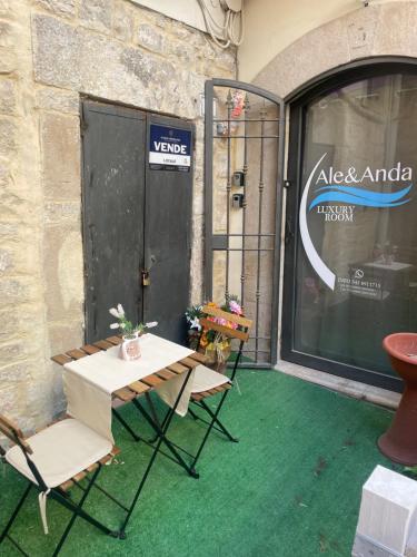 a patio with two chairs and a table and a door at Ale&Anda Luxury Room in Trani