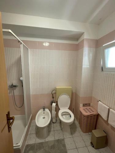 a bathroom with a toilet and a sink at Studio Apartman Bubi in Nečujam
