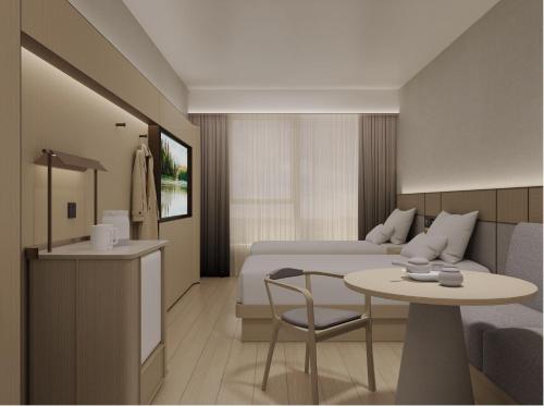 a hotel room with a bed and a table and chair at JI Hotel Beijing Changping Nanshao Subway Station in Beijing