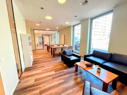 a living room with a couch and a table at ARISER - Luzern Kriens Business Suites in Luzern
