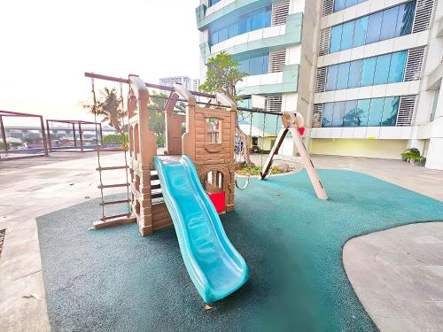 a playground with a slide and a slideintend at Apatermend grand kamala lagoon 1BR Cozy & Elegant by LuckyStay in Pulosirih