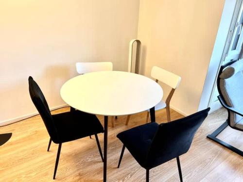 a white table and chairs in a room at Brand New City Center downtown apartment, Zurich Brauer - Self Checkin in Zurich
