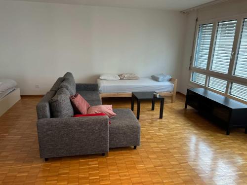 a living room with a couch and a bed at Large Flat, Downtown Center next to Zurich HB Main Station Muller - Self Checkin in Zürich