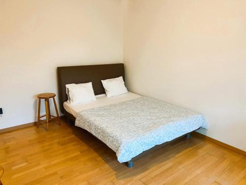 a small bed in a room with a wooden floor at Charming City Center Flat with Balcony Steps from Zurich Historic Schloss in Zürich