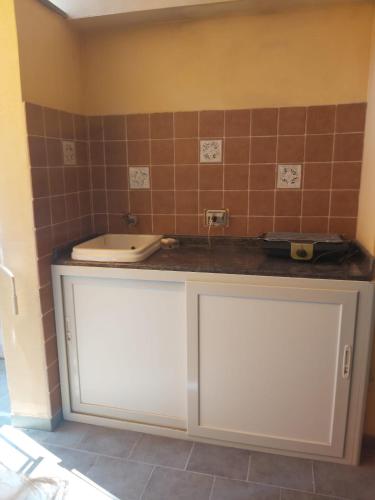 a bathroom with a sink and a toilet on a counter at SANT'ALESSIO BEACH HOLIDAY in SantʼAlessio Siculo