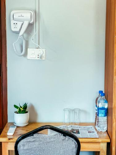 a suitcase sitting on a table with a phone at Kairos Bed & Breakfast in Pātan