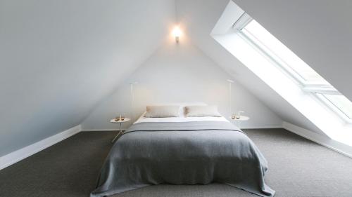 a bedroom with a bed in a attic at côté verger B&B in Battice