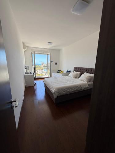 a bedroom with a bed and a view of the ocean at Sargo Apartman Bar in Bar