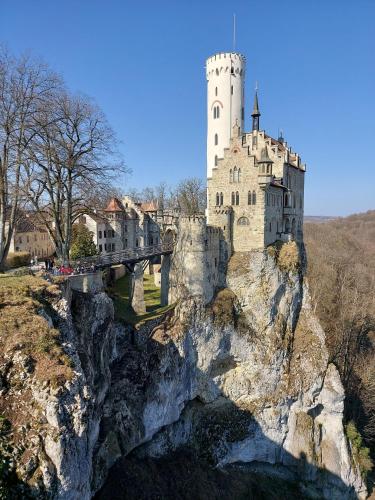 a castle on top of a mountain with a bridge at Ferienwohnung Felsenblick in Albstadt