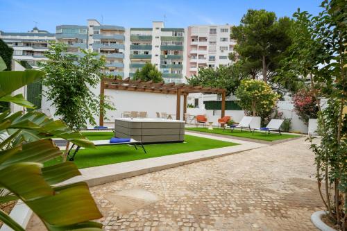 a garden with a bench and a pergola at Urban Bliss Boutique Guesthouse in Faro
