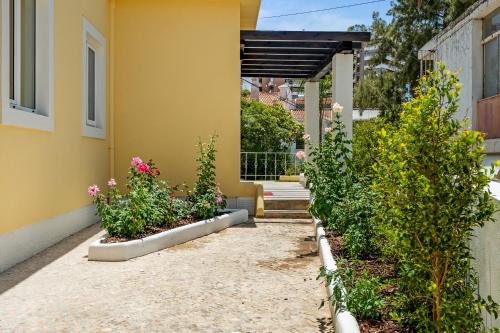 a house with plants in front of a building at Urban Bliss Boutique Guesthouse in Faro