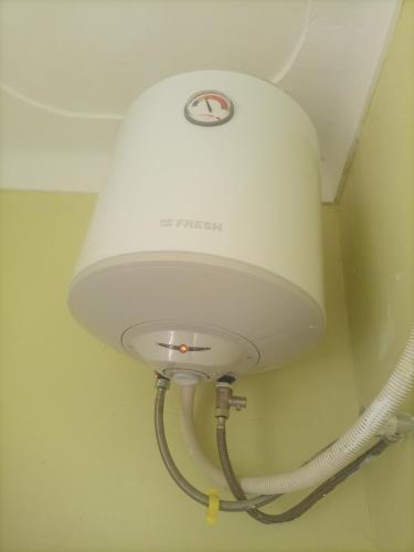 a white light on a ceiling with a hose at Pearl furnished residence in Buloba