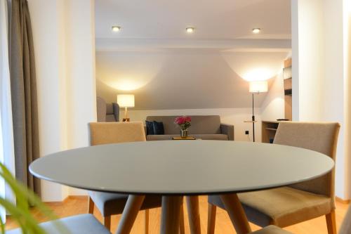 a white table and chairs in a room at Landgasthof Sagenhaft in Klagenfurt