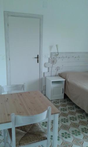 a room with a table and a bed and a table and chairs at Residence Villa Olivia in Ischia