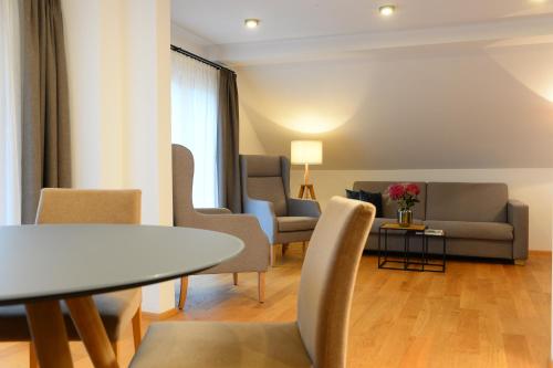 a living room with a table and chairs at Landgasthof Sagenhaft in Klagenfurt