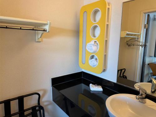 a bathroom with a sink and a mirror at Studio 6 Suites Las Vegas, NV - Tropicana in Las Vegas