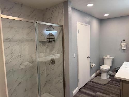a bathroom with a shower and a toilet at Studio 6 Suites Las Vegas, NV - Tropicana in Las Vegas