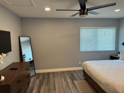 a bedroom with a bed and a ceiling fan at Studio 6 Suites Las Vegas, NV - Tropicana in Las Vegas