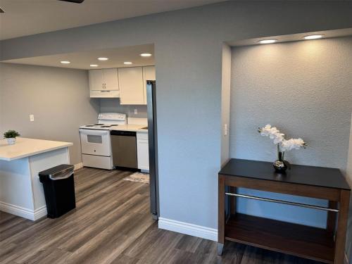 a small kitchen with a table with flowers on it at Studio 6 Suites Las Vegas, NV - Tropicana in Las Vegas