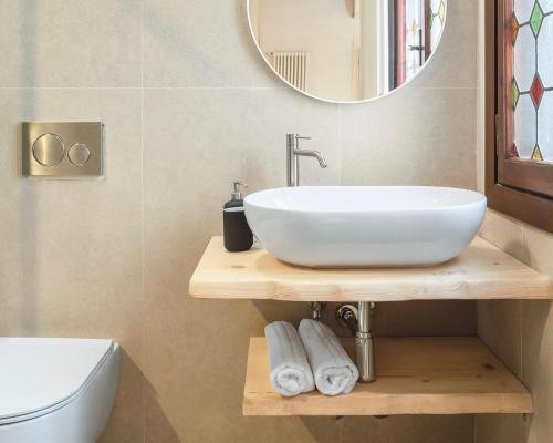 a bathroom with a white sink and a mirror at QN Apartments in Venice