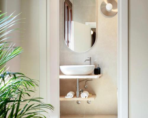 a bathroom with a sink and a mirror at QN Apartments in Venice