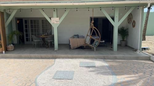 a porch of a house with a table and a patio at Rock Palma Apartments - Cozy, spacious and family friendly in Noord