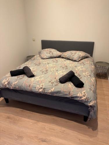 a bedroom with a bed with two pillows on it at C-side in Blankenberge