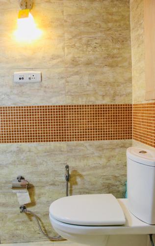 a bathroom with a white toilet in a room at AHA Luxury Villa - 3BR Retreat in Central Udaipur in Udaipur