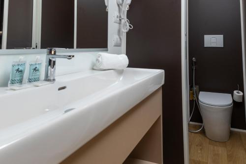 a bathroom with a white sink and a toilet at hu Firenze Certosa camping in town in Impruneta