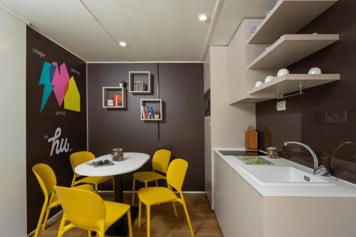 a kitchen with yellow chairs and a table and a sink at hu Firenze Certosa camping in town in Impruneta