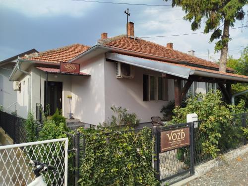a white house with a sign in front of it at Vožd Apartmani in Kladovo