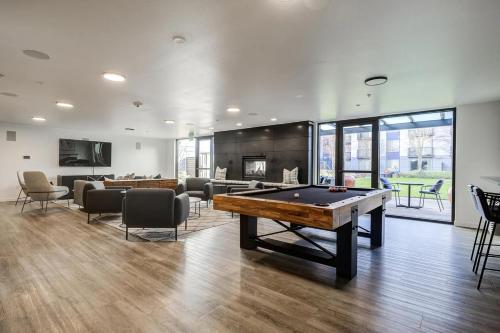 a living room with a pool table and a fireplace at Blueground Brighton balcony nr Seward Park SEA-874 in Seattle