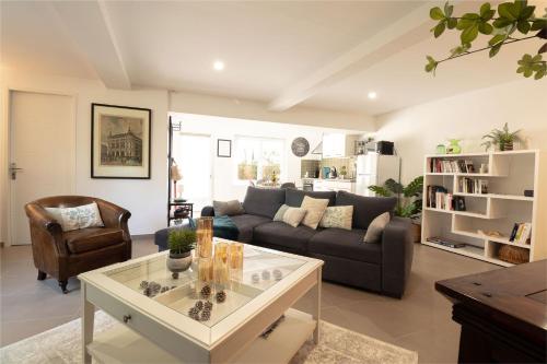 a living room with a couch and a coffee table at Gîte Marsau in Lacourt-Saint-Pierre