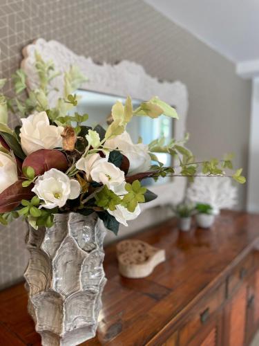 a vase filled with flowers on top of a table at Gîte Marsau in Lacourt-Saint-Pierre