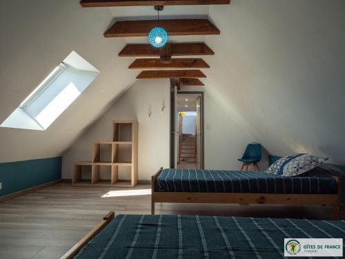 a bedroom with a bed and a skylight at Gite Le Sauvage in Sébrazac
