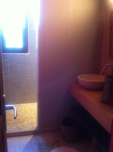 a bathroom with a toilet and a sink at L'ancienne Grange in Clairvaux-dʼAveyron